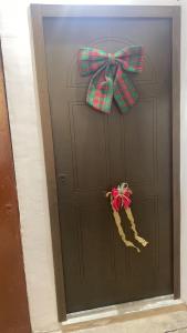 a door with a plaid bow and a stocking at A mare,Pozzuoli-Licola in Licola