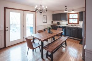 a dining room with a wooden table and chairs at Bigfoot's Hideout - A Hocking Hills Escape in Logan