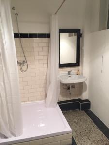 a white bathroom with a sink and a shower at Central Pension in Duisburg