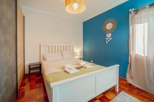 En eller flere senge i et værelse på Casa das Orquideas by Vacationy