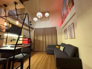 a living room with a couch and a table at Studio 2 Port Valencia in Valencia
