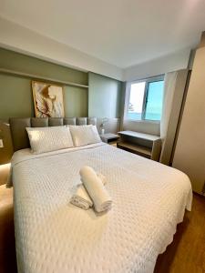 A bed or beds in a room at Flat Hotel à Beira Mar Recife by Direct
