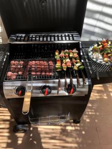 a grill with a bunch of food on it at premium farmhouse with pool Rabat in Rabat