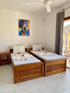 Postel nebo postele na pokoji v ubytování Boutique Ocean View Nungwi