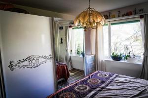 a bedroom with a bed and a chandelier at Lutyma in Basel