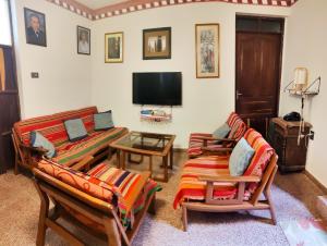 a living room with couches and a flat screen tv at Hostal Margaritas - Torotoro in Torotoro