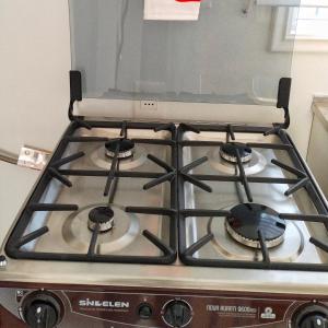 a stove top oven sitting in a kitchen at Petrohue I in Valdivia