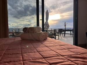 ein Stapel Handtücher auf einem Bett in der Unterkunft Calheta Ocean View Family Apartment - Air Condition in Estreito da Calheta