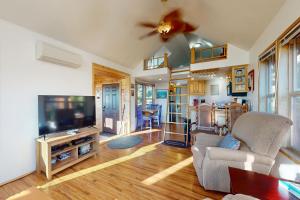 a living room with a couch and a tv at The Frosty Walrus in Carpenterville