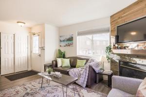 a living room with a couch and a fireplace at Entire Lovely Townhouse Mountain View! in Canmore