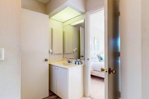 a bathroom with a sink and a mirror at Sun and Sand Oasis in Venice +17 photos