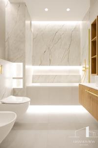 Un baño blanco con inodoro y lavabo. en Penthouse Brabank Luxury Japandi Sauna&Fitness free parking by Grandview, en Gdansk 52 fotos más