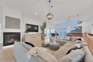 a living room with a couch and a fireplace at Oceanfront Villa On Semi-Private Holywood Beach in Hollywood