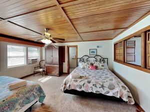 a bedroom with a bed and a ceiling fan at The Hidden Porpoise in Port Aransas