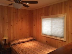 a bedroom with a bed and a window at Victoria Harbour Cottages in Victoria Harbour