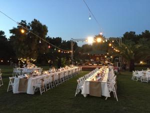 a group of tables with white chairs and lights at Denizati Holiday Village in Gumuldur +117 photos