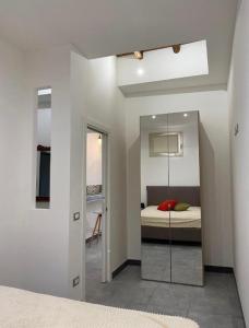 a bedroom with a bed and a mirror at SEA & CITY Apartments in Trapani