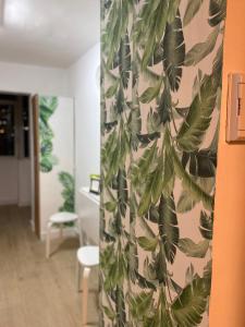 a room with a curtain with leaves on a wall at Casa Eneri in Los Cristianos