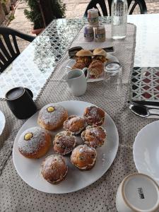 a plate of donuts sitting on top of a table at Il Sentiero beb in Verona