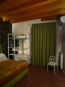 a bedroom with a bed and a green curtain at Abside Suite & Spa in Palermo