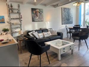 a living room with a couch and a table at Maison de pêcheur atypique in Cagnes-sur-Mer