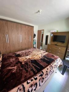 a bedroom with a large bed and a television at aconchegante e tranquila in Parnamirim +24 photos