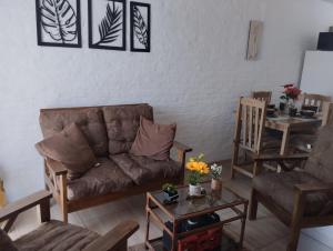 a living room with a couch and a table at Lugar tranquilo in Colonia del Sacramento