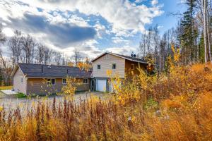 a house in the middle of a field at Convenient Fairbanks Guest Suite with Grill! in Fairbanks