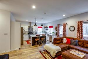 a living room with a couch and a kitchen at Convenient Fairbanks Guest Suite with Grill! in Fairbanks