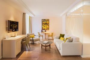 a living room with a couch and a table at Hôtel Mont-Blanc Chamonix in Chamonix