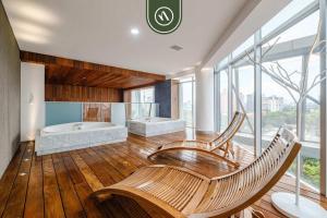 a large bathroom with two chairs and a tub at 2 BR Condo in Polanco with Pool and Gym in Mexico City