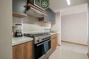 a kitchen with a stove and a counter top at 2 BR Condo in Polanco with Pool and Gym in Mexico City