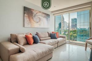 a living room with a couch and a large window at 2 BR Condo in Polanco with Pool and Gym in Mexico City