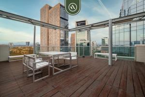 a balcony with a table and chairs on a building at 2 BR Condo in Polanco with Pool and Gym in Mexico City