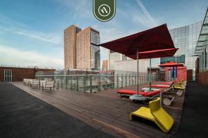a deck with a group of benches and an umbrella at 2 BR Condo in Polanco with Pool and Gym in Mexico City