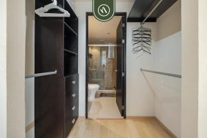 a bathroom with a black closet and a toilet at 2 BR Condo in Polanco with Pool and Gym in Mexico City +30 photos