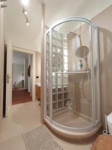 a glass shower in a bathroom with a hallway at Le Petit Nottolini in Lucca
