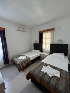 Ένα ή περισσότερα κρεβάτια σε δωμάτιο στο Ege Apartments