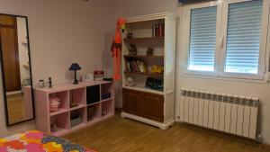a childs bedroom with a book shelf and a window at Vivienda Rural Paraje El Sotillo in Carchel