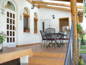 a patio with a table and chairs on it at Fehér Ló Fogadó in Bük