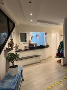a living room with a christmas tree in a room at Bike Hotel Oasi in Finale Ligure