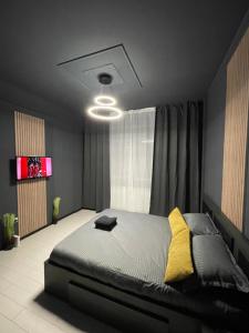 a bedroom with a large bed and a television at Militari Residence Luxury 23 in Roşu +20 photos
