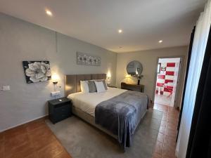 a bedroom with a large bed and a mirror at Casa Paula Villas - Private Heated Pool for Each House in Lagos