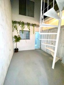 an empty room with a staircase and a potted plant at Departamento Getsemani in Hermosillo +38 photos