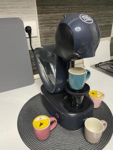 a coffee maker sitting on a counter with two cups at Militari Residence Luxury 32 in Roşu +18 photos
