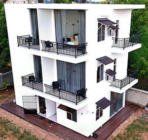 an aerial view of a white building with balconies at Shalom Resorts Yala in Tissamaharama