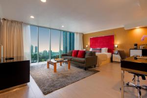 a living room with a couch and a large window at Executive Suites Hotel & Conference Center, Metro Vancouver in Burnaby