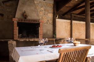 a table with wine glasses and a plate of fruit on it at Apartamentos Casa La Cuca in Alfambra