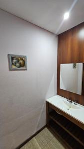 a bathroom with a sink and a mirror at Mirasoles Hotel in Mina Clavero