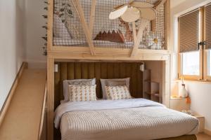 a bedroom with a wooden canopy bed with pillows at Babka in Białka Tatrzańska